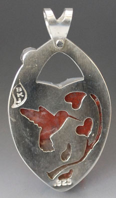 Back of heart pendant with cut-out hummingbird