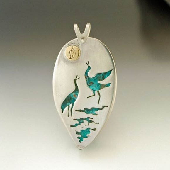 Back of chrysocolla pendant - two cranes