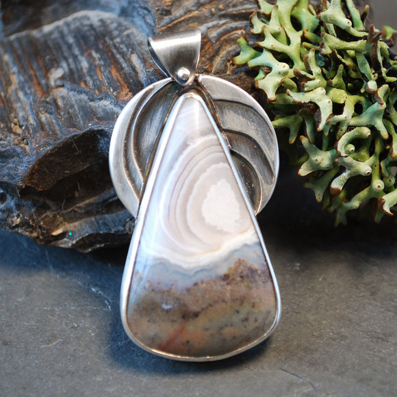 Tundra Pendant: Silver pendant with Fortification Agate (Arizona) - layered silver "swoops" mimicking pattern in stone