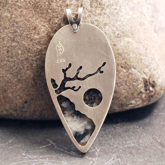 Back of Josephine's Crown pendant - tree leaning out from a cliffside, mimicking pattern in stone