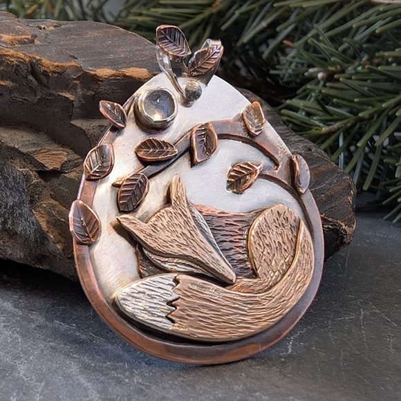 Silver pendant with bronze fox, copper branches and leaves, and moonstone.