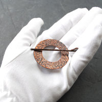 Rustic Hammered Copper Shawl Pin on scarf in hand