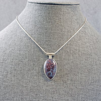 Agate Pendant with Rose Cut-Out in Back, hanging on chain