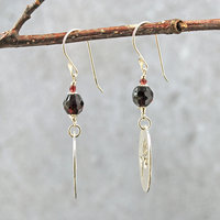 Silver Rose cut-out garnet earrings, hanging side view