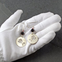 Silver Rose cut-out garnet earrings, in hand