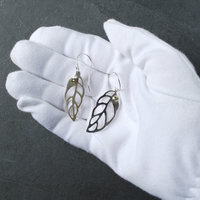 Silver Leaf Earrings with Peridot in  hand
