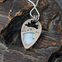 Larimar silver pendant back with tropical fish cut out behind stone