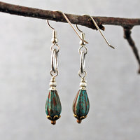 Silver ring and Czech glass teal earrings hanging-side view