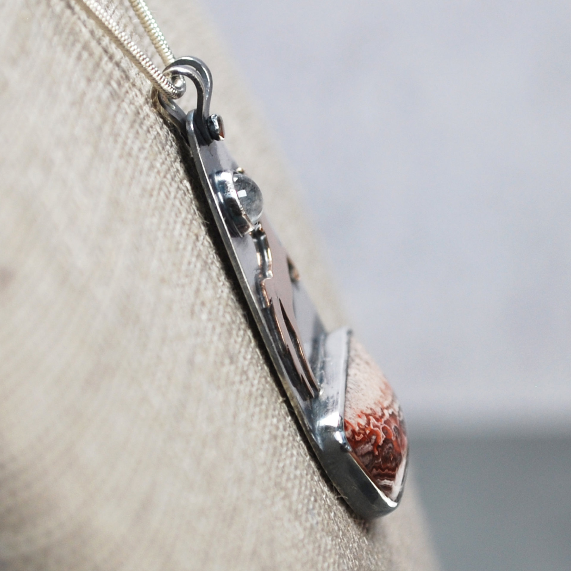 Crazy Lace Agate Pendant with Horse, Moonstone close-up angle
