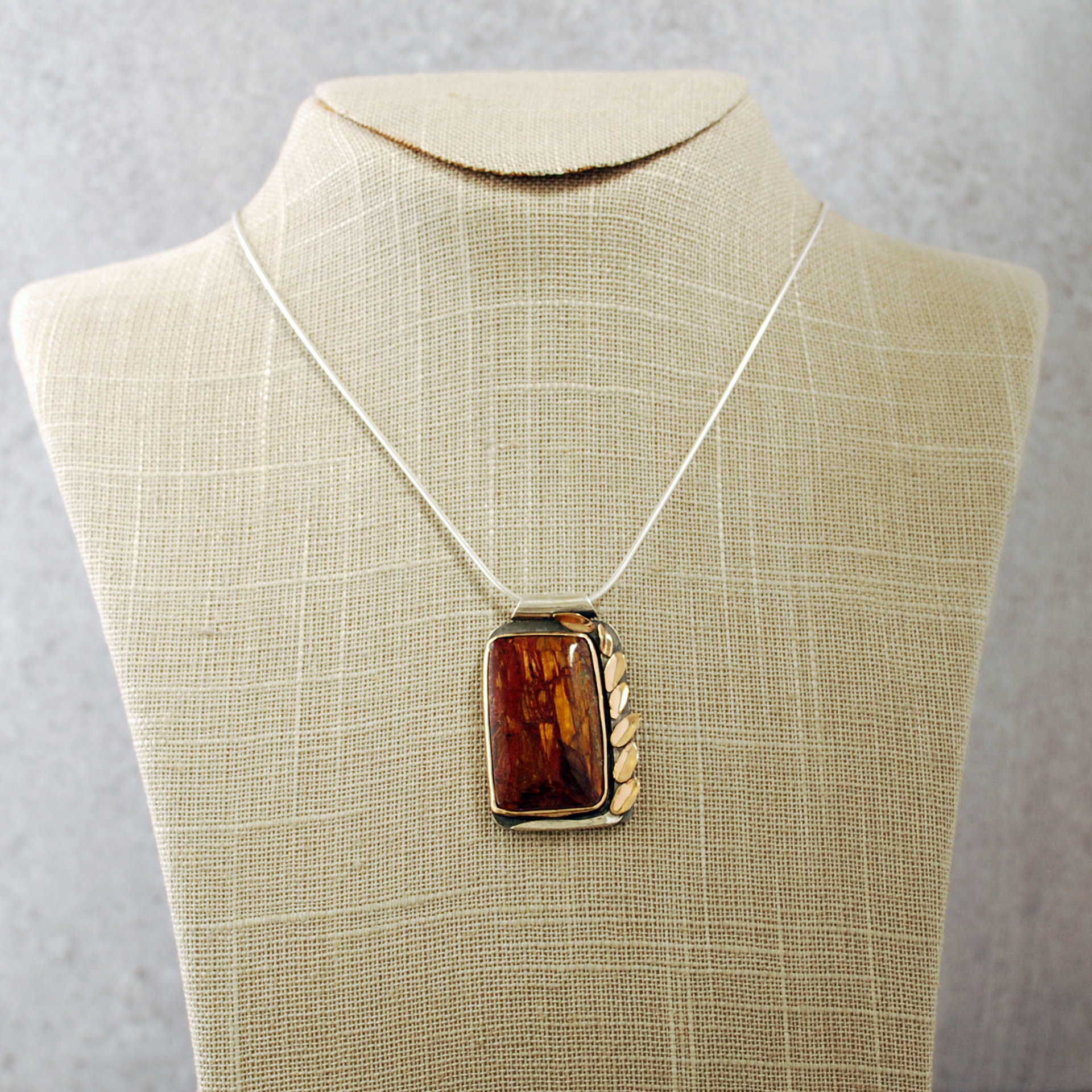 Silver and 14K Gold Pietersite Pendant hanging