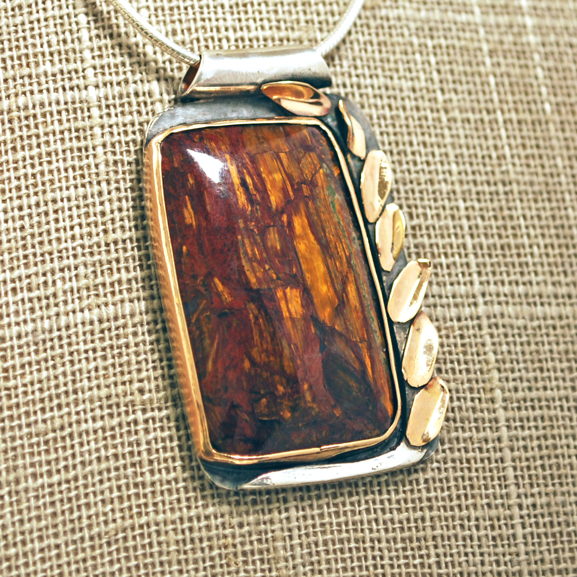 Silver and 14K Gold Pietersite Pendant close-up angle view