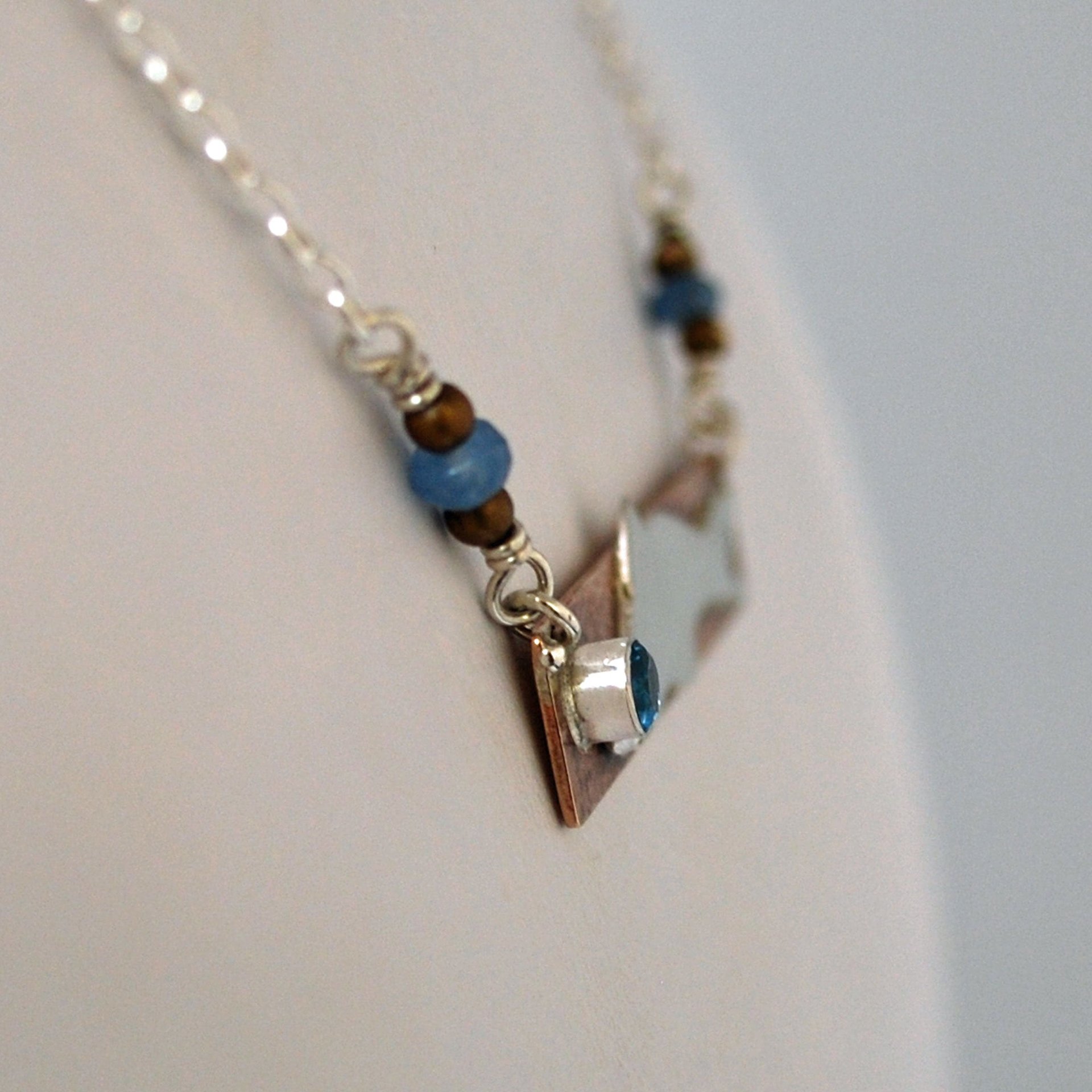 Hammered Bronze Bar Necklace with Happy Silver Fish and Blue Topaz