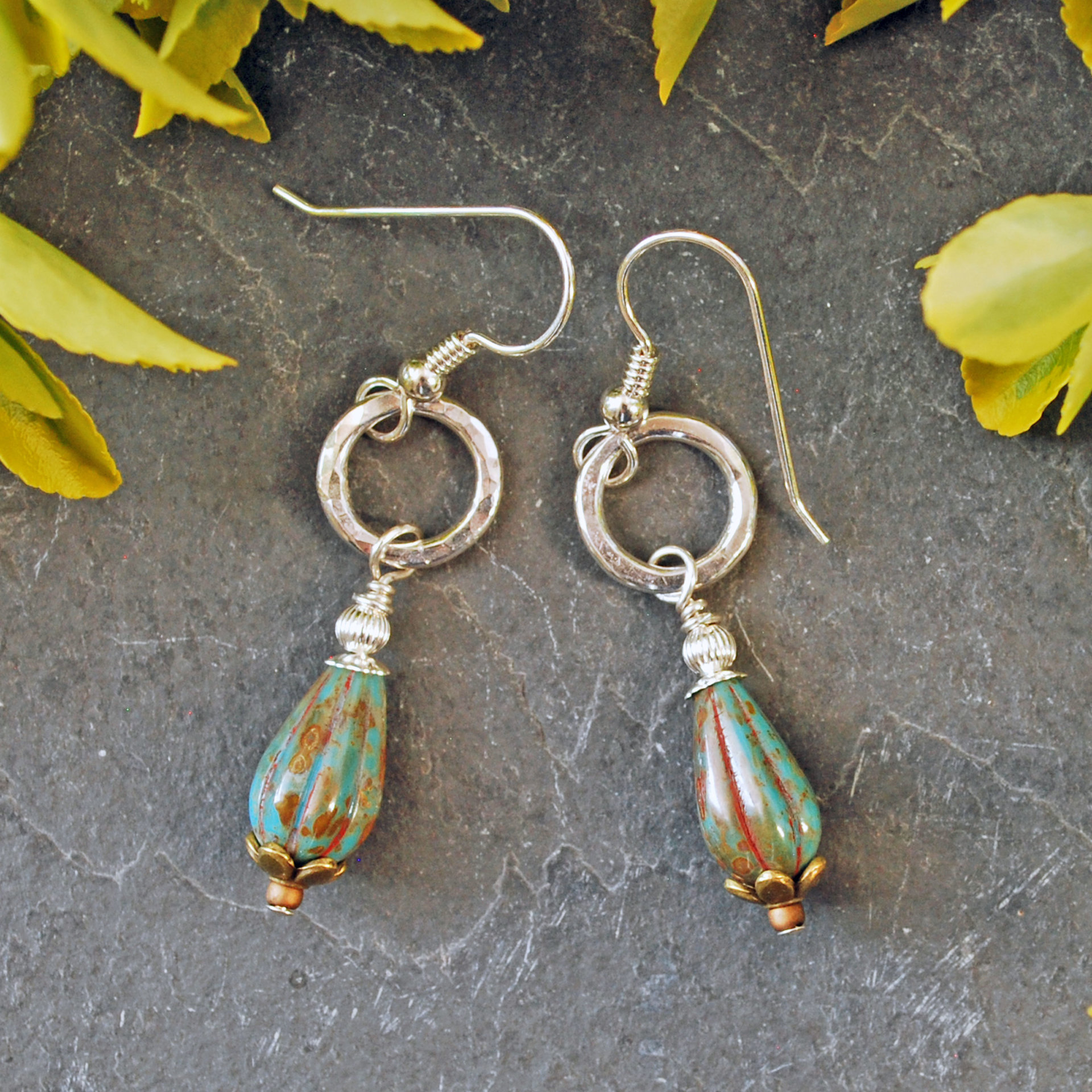 Earrings with hammered silver ring and melon shaped, teal Czech glass tear drop beads