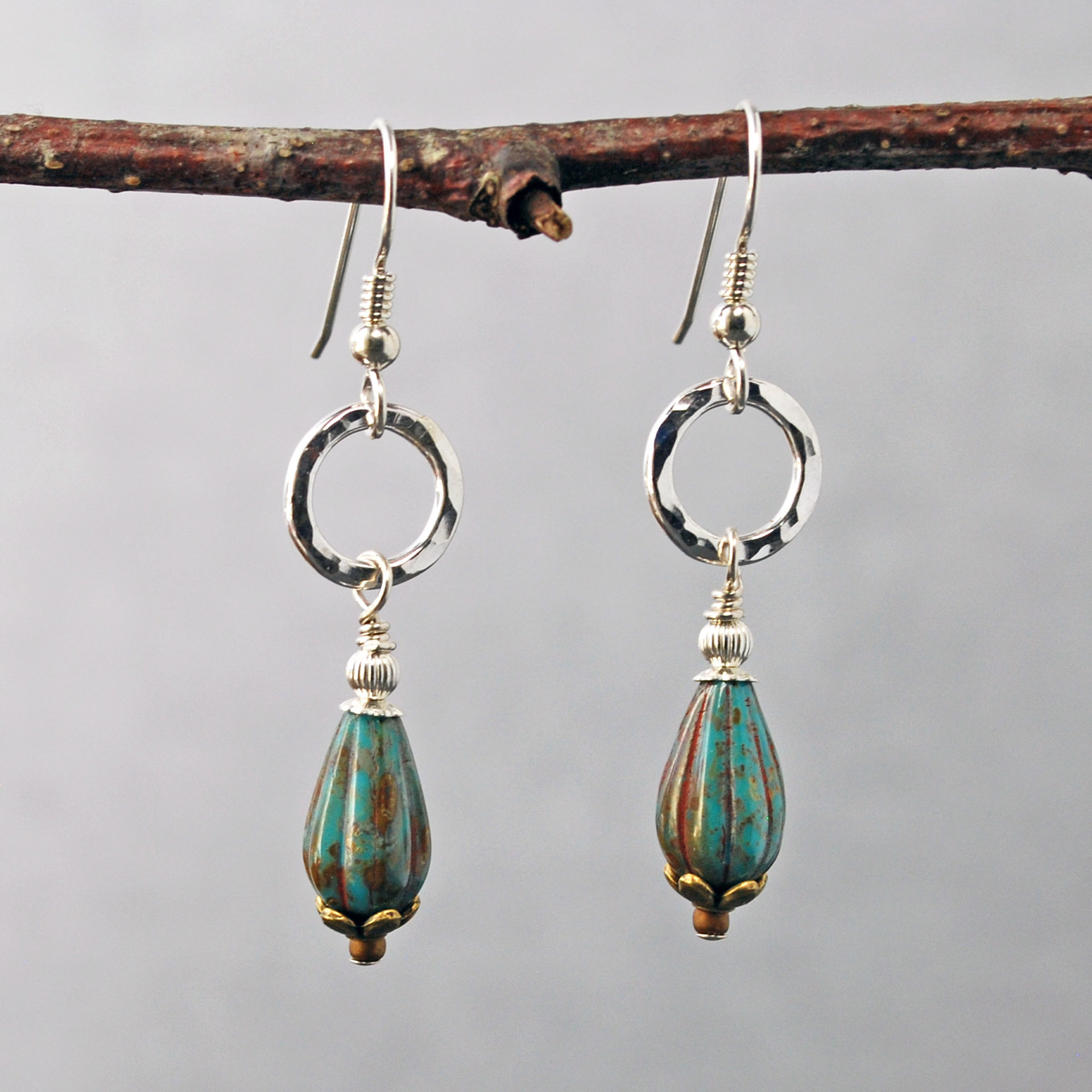 Silver ring and Czech glass teal earrings hanging