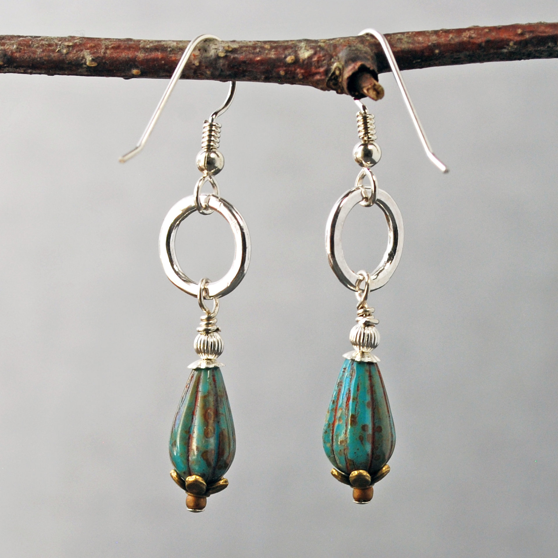 Silver ring and Czech glass teal earrings hanging-back view
