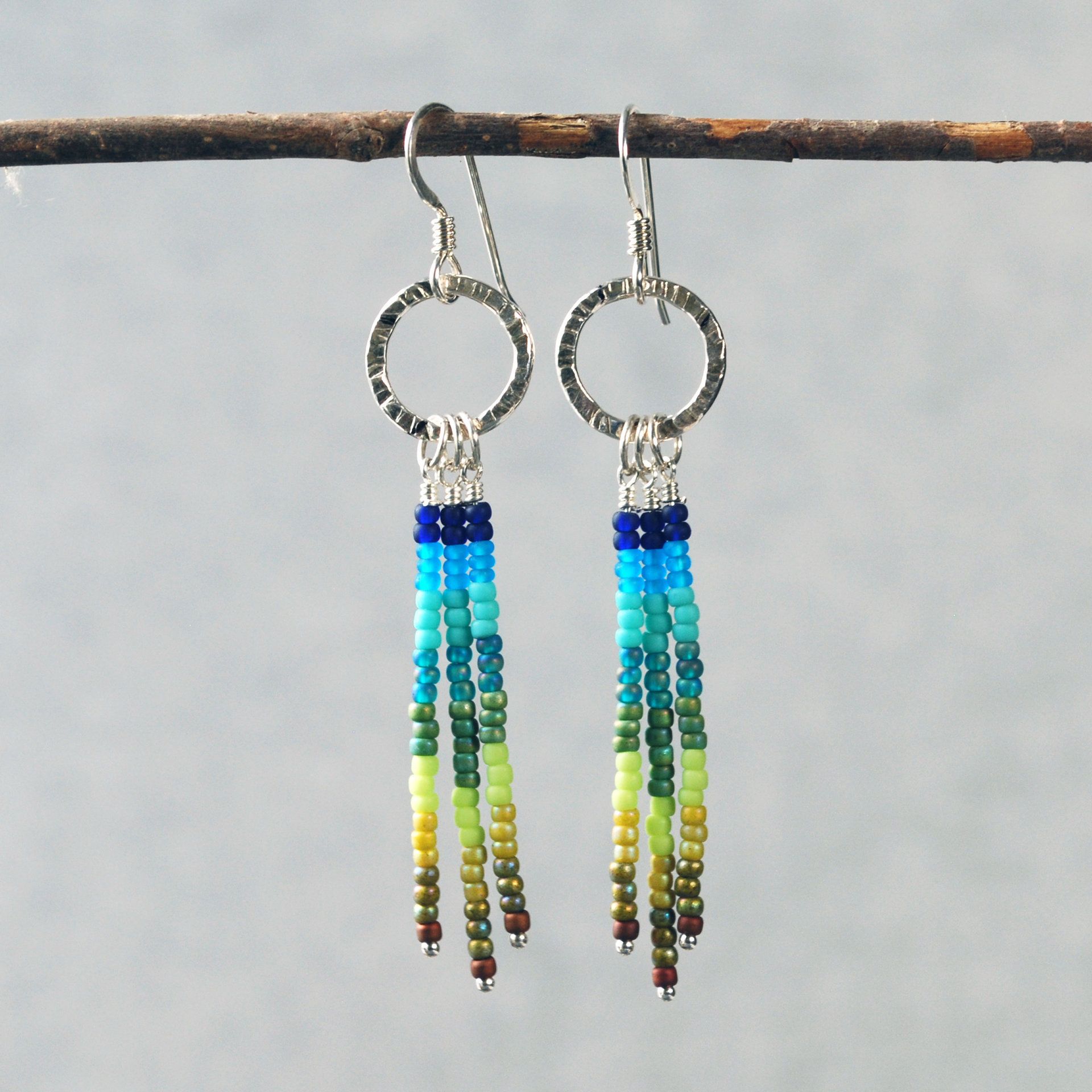 Silver earrings with blue and green dangles