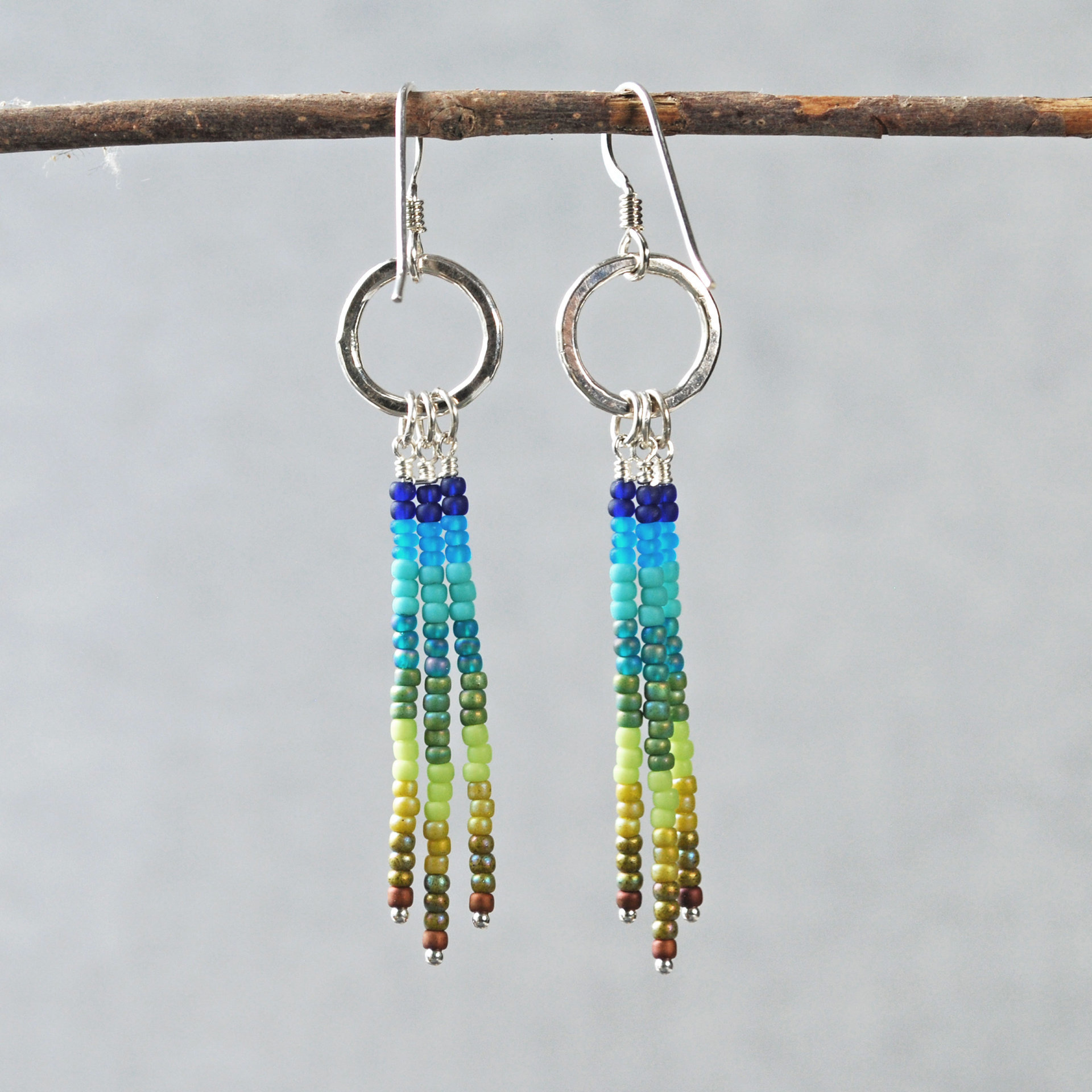 Silver earrings with blue and green dangles